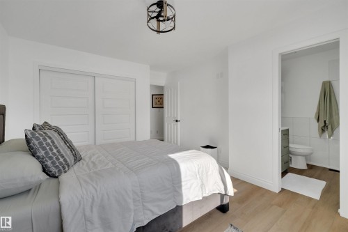 Bedroom featuring light-toned flooring, white walls, and a ceiling light fixture - 131 West Liberty Crescent, Millet, AB - Indoor Photo Showing Bedroom