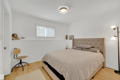 Bedroom with light wood flooring, white walls, and a window with blinds - 131 West Liberty Crescent, Millet, AB - Indoor Photo Showing Bedroom