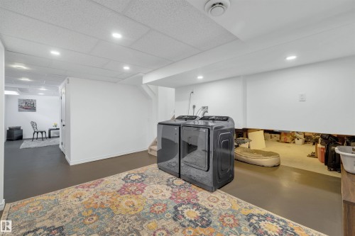 The property includes a dedicated laundry area with a washer and dryer, recessed lighting, and a neutral color palette - 131 West Liberty Crescent, Millet, AB - Indoor Photo Showing Basement