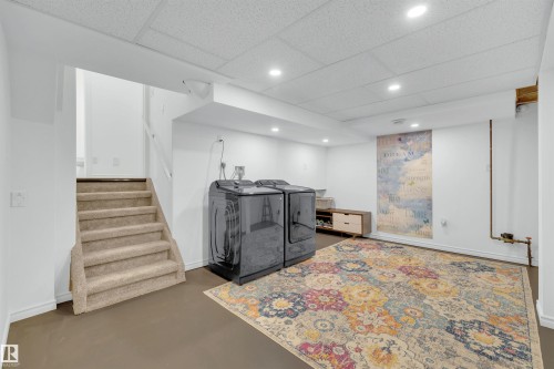 Spacious lower level with recessed lighting and neutral walls, featuring a carpeted staircase and durable flooring - 131 West Liberty Crescent, Millet, AB - Indoor Photo Showing Other Room