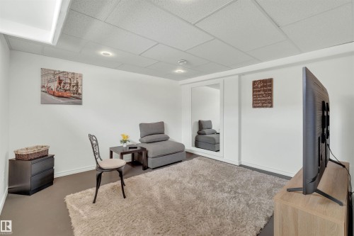 This room features light-colored walls and a drop ceiling with recessed lighting - 131 West Liberty Crescent, Millet, AB - Indoor