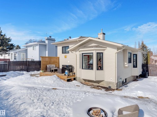 The property features an exterior with beige siding, black-framed windows, and a bay window projection - 131 West Liberty Crescent, Millet, AB - Outdoor