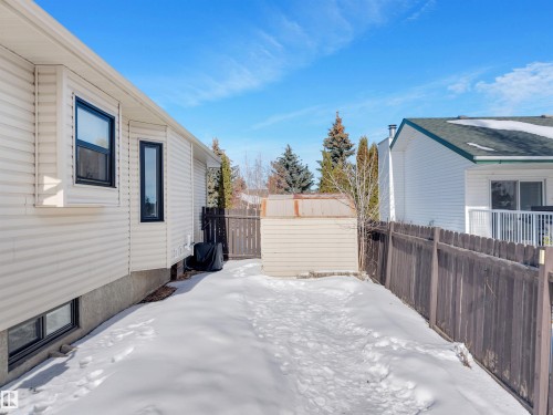 The property features a private yard with a shed and a wooden fence - 131 West Liberty Crescent, Millet, AB - Outdoor With Exterior