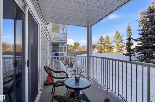 Balcony with sliding glass doors, a white metal railing, and an outdoor seating area - 115 2208 44 Avenue, Edmonton, AB - Outdoor With Exterior