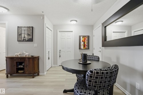 This area features light-toned flooring, white doors, and a ceiling fan - 115 2208 44 Avenue, Edmonton, AB - Indoor