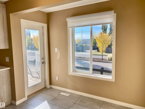 Entryway featuring baseboards and tile patterned flooring - 403 178 Bridgeport Boulevard, Leduc, AB - Indoor Photo Showing Other Room