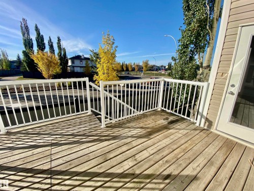 Wooden terrace featuring a residential view - 403 178 Bridgeport Boulevard, Leduc, AB - Outdoor With Deck Patio Veranda With Exterior