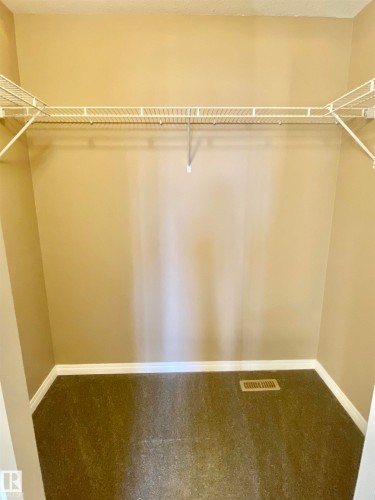 Walk in closet with carpet - 403 178 Bridgeport Boulevard, Leduc, AB - Indoor With Storage