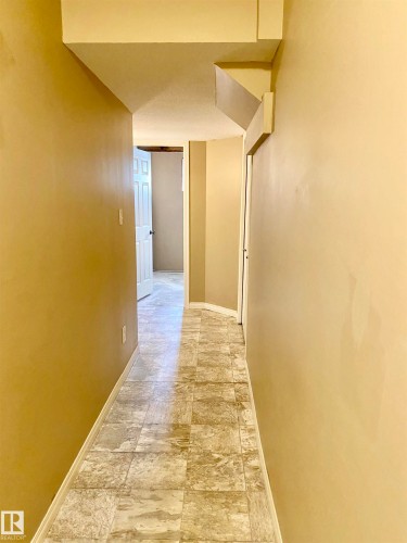 Hallway with baseboards - 403 178 Bridgeport Boulevard, Leduc, AB - Indoor Photo Showing Other Room