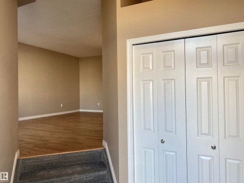 Stairway with baseboards - 403 178 Bridgeport Boulevard, Leduc, AB - Indoor Photo Showing Other Room