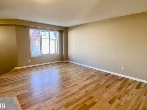 Spare room featuring light wood finished floors and baseboards - 403 178 Bridgeport Boulevard, Leduc, AB - Indoor Photo Showing Other Room