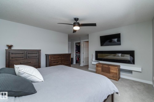 The room features light gray walls, a ceiling fan with integrated lighting, and carpeted floors - 7608 179 Avenue, Edmonton, AB - Indoor Photo Showing Bedroom
