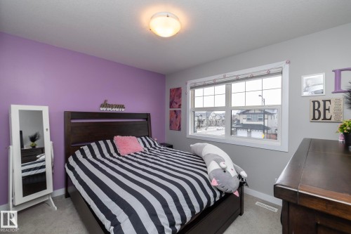 This room features light grey carpeting and a window providing a view of the surrounding properties - 7608 179 Avenue, Edmonton, AB - Indoor Photo Showing Bedroom