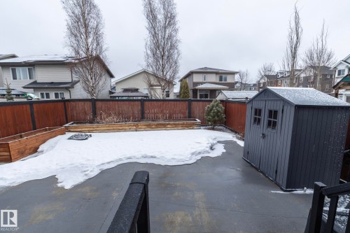 The property features a fenced yard with a concrete patio, a storage shed, and planter boxes - 7608 179 Avenue, Edmonton, AB - Outdoor