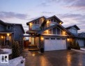The property features a two-car garage, a stone facade, and exterior lighting - 7608 179 Avenue, Edmonton, AB  - Outdoor With Facade 
