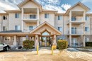 The property features a multi-story exterior with a stucco finish and balconies on the upper levels - 126 16221 95 Street, Edmonton, AB  - Outdoor With Facade 