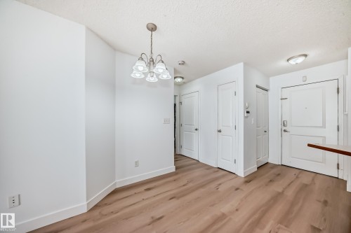 The property features light wood flooring, white walls, and white doors, creating a bright and cohesive interior - 126 16221 95 Street, Edmonton, AB - Indoor Photo Showing Other Room