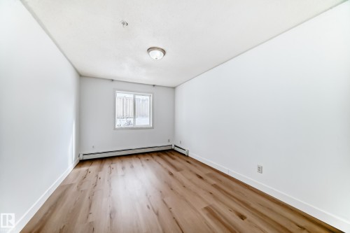 This room features light wood flooring and white walls, creating a bright and airy atmosphere - 126 16221 95 Street, Edmonton, AB - Indoor Photo Showing Other Room