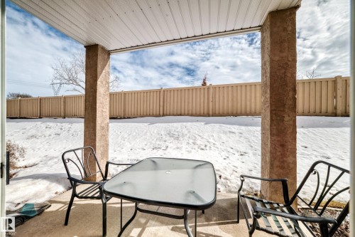 The property features a concrete patio area with a covered ceiling - 126 16221 95 Street, Edmonton, AB - Outdoor With Deck Patio Veranda With Exterior