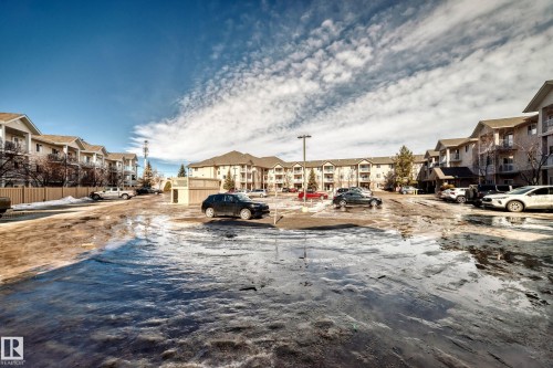 The property is part of a complex featuring multi-story buildings with balconies and sloped roofs - 126 16221 95 Street, Edmonton, AB - Outdoor