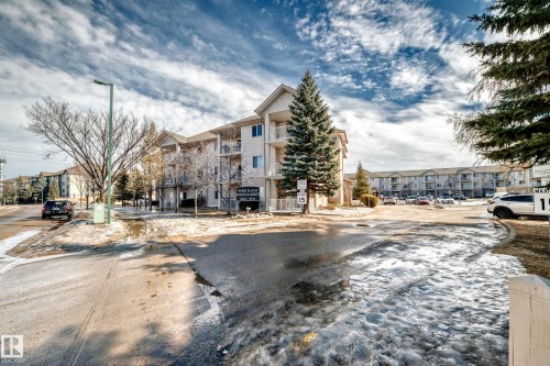 The property features a multi-story building with a light-colored facade and balconies - 126 16221 95 Street, Edmonton, AB - Outdoor