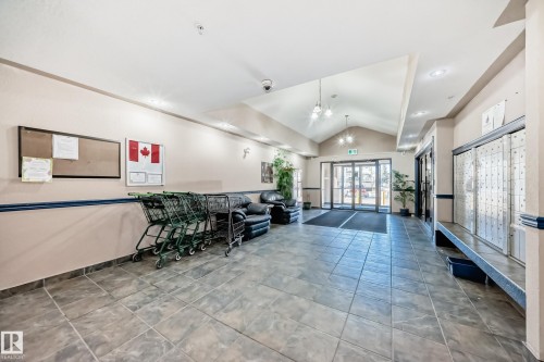 The property features a spacious lobby with tiled flooring, vaulted ceilings, and recessed lighting - 126 16221 95 Street, Edmonton, AB - Indoor Photo Showing Other Room