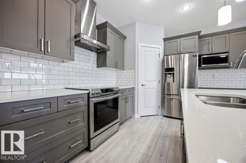 1057 Coopers Hawk Link, Edmonton, AB - Indoor Photo Showing Kitchen With Stainless Steel Kitchen With Double Sink With Upgraded Kitchen
