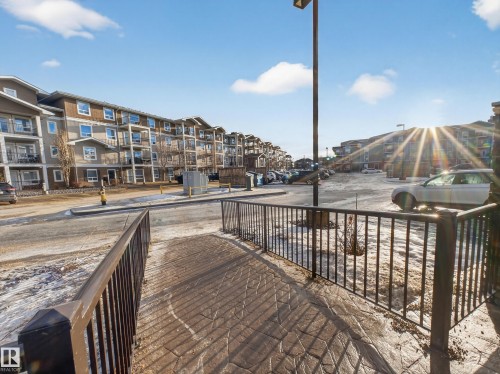 View of the property's exterior, featuring multi-story buildings with balconies, and a paved parking area - 1111 9363 Simpson Drive, Edmonton, AB - Outdoor