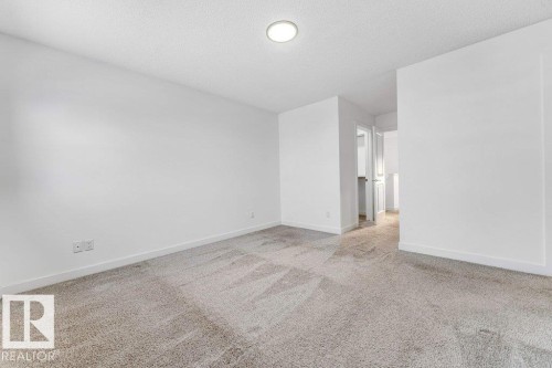 This room features light-colored carpet, white walls, and a recessed ceiling light - 1912 27 Street Nw, Edmonton, AB - Indoor Photo Showing Other Room