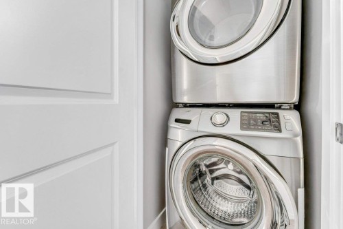 Dedicated laundry space with a stacked washer and dryer unit - 1912 27 Street Nw, Edmonton, AB - Indoor Photo Showing Laundry Room