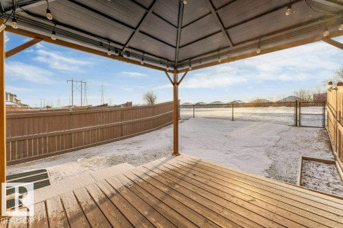 The property features a spacious wooden deck with a covered gazebo, offering an outdoor living space - 1912 27 Street Nw, Edmonton, AB - Outdoor With Deck Patio Veranda With Exterior