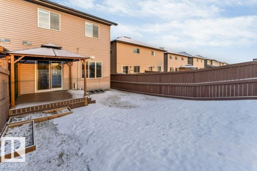 The property features a fenced backyard with a patio area and an attached gazebo - 1912 27 Street Nw, Edmonton, AB - Outdoor With Exterior