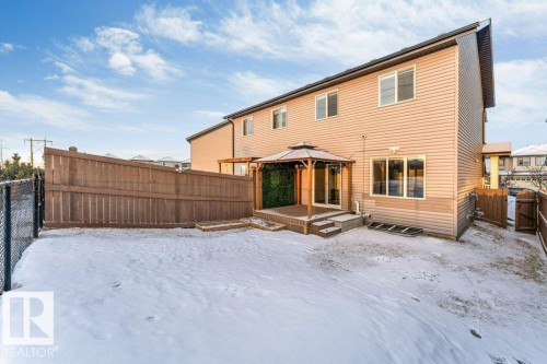 The property features a private yard with a wooden fence and a gazebo structure on a deck - 1912 27 Street Nw, Edmonton, AB - Outdoor With Exterior