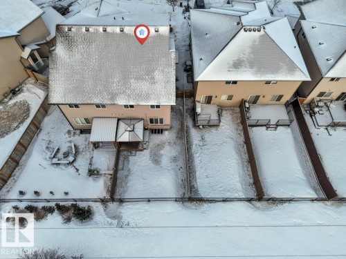 Aerial view of the property, showcasing the rear exterior with a covered patio area and a fenced backyard - 1912 27 Street Nw, Edmonton, AB - Outdoor