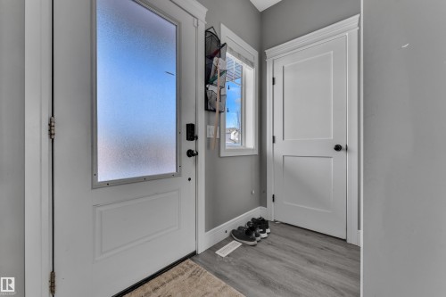 Entryway featuring a white door with frosted glass, gray walls, and light gray flooring - 195 Kirpatrick Way, Leduc, AB - Indoor Photo Showing Other Room