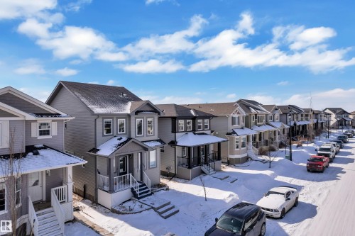 This property features a two-story design with light gray siding and dark trim - 195 Kirpatrick Way, Leduc, AB - Outdoor