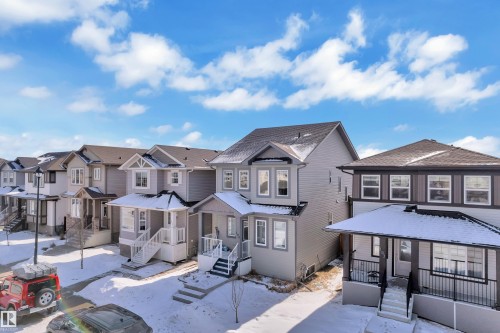 This property features a contemporary architectural style with light gray siding and dark trim - 195 Kirpatrick Way, Leduc, AB - Outdoor With Facade