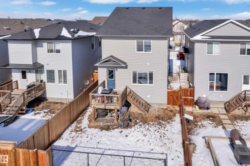 The property features a two-story exterior with light-colored siding and a dark roof - 195 Kirpatrick Way, Leduc, AB - Outdoor