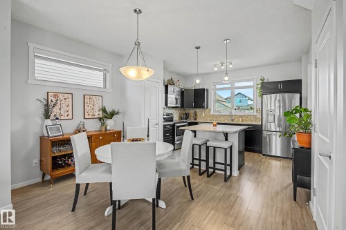 Dining area with baseboards and light wood-style flooring - 4110 Allan Crescent, Edmonton, AB - Indoor Photo Showing Other Room