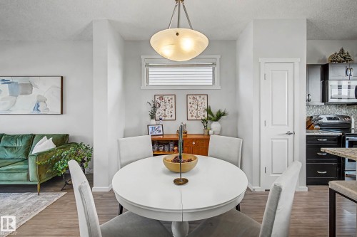 Dining space with a textured ceiling and wood finished floors - 4110 Allan Crescent, Edmonton, AB - Indoor Photo Showing Dining Room