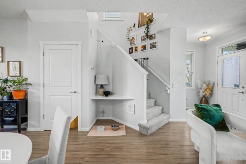 Entryway featuring a textured ceiling and wood finished floors - 4110 Allan Crescent, Edmonton, AB - Indoor Photo Showing Other Room