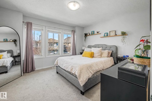 Bedroom with light carpet and a textured ceiling - 4110 Allan Crescent, Edmonton, AB - Indoor Photo Showing Bedroom