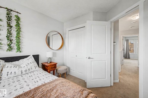 Bedroom with light carpet, a closet, and a textured ceiling - 4110 Allan Crescent, Edmonton, AB - Indoor Photo Showing Bedroom