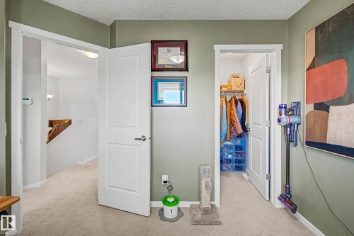 Hall with light carpet and a textured ceiling - 4110 Allan Crescent, Edmonton, AB - Indoor Photo Showing Other Room