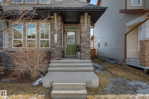 View of exterior entry featuring roof with shingles and stone siding - 4110 Allan Crescent, Edmonton, AB - Outdoor