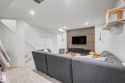 Living room featuring light colored carpet and recessed lighting - 4110 Allan Crescent, Edmonton, AB - Indoor
