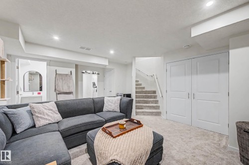 Living area with carpet floors, recessed lighting, and a textured ceiling - 4110 Allan Crescent, Edmonton, AB - Indoor Photo Showing Living Room