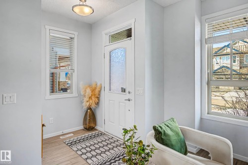 Entrance foyer featuring light wood finished floors and a textured ceiling - 4110 Allan Crescent, Edmonton, AB - Indoor Photo Showing Other Room