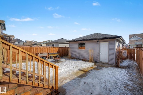 Snowy yard featuring a fenced backyard, a patio, and a residential view - 4110 Allan Crescent, Edmonton, AB - Outdoor With Exterior