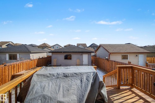 Wooden terrace featuring a residential view and a fenced backyard - 4110 Allan Crescent, Edmonton, AB - Outdoor With Exterior